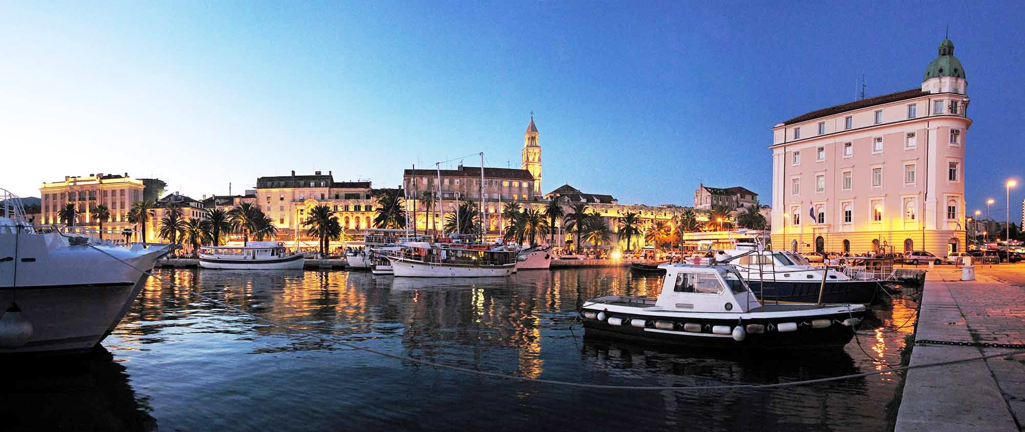Port of Split, Croatia south facade of Diocletian palace and port authority building, night view from the seaside